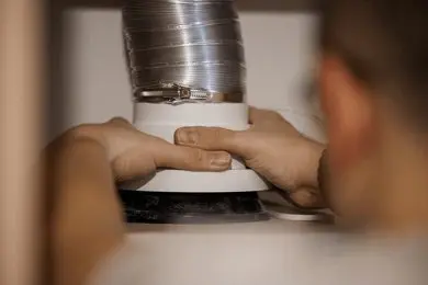 Technician installing a new dryer vent system for proper ventilation