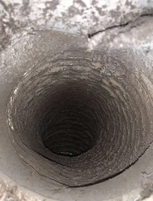 Clogged dryer vent filled with lint before cleaning by Air i Am Duct & Chimney Services Houston